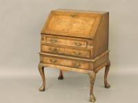 Lot 496 - A Queen Anne style walnut and feather strung writing desk