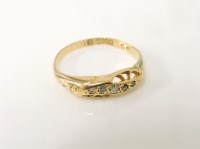 Lot 9 - An 18ct gold boat shape crossover five stone graduated diamond ring