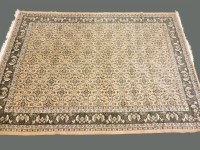 Lot 519 - An Oriental fawn ground rug