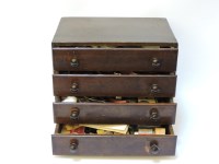 Lot 354 - Clock and watch maker's spares in a four drawer cabinet