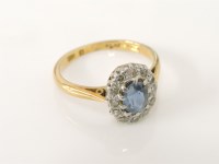 Lot 13 - An oval cut sapphire and diamond cluster ring