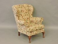 Lot 494 - A 20th century wingback armchair