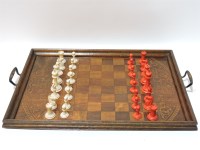 Lot 338 - A late 19th century carved bone natural and stained chess set