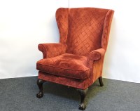 Lot 440 - A red upholstered wing chair