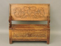 Lot 532 - A 20th century oak and carved monk's bench