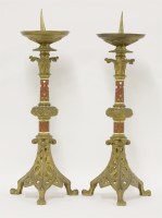 Lot 63 - A pair of French Gothic gilt bronze and champlevé pricket candlesticks