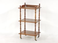 Lot 585 - A Victorian walnut three tier whatnot