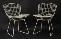 Lot 556 - A pair of white wire mesh side chairs