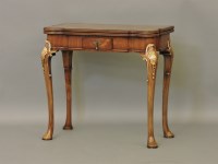 Lot 379 - A reproduction George III walnut and gilt fold over top card table