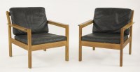 Lot 606 - A pair of oak lounge armchairs