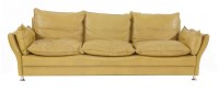 Lot 517 - A tan leather three-seater settee