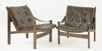 Lot 518 - A pair of stained beechwood and leather loungers