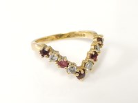 Lot 209 - An 18ct gold ruby and diamond half wishbone ring