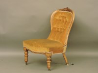 Lot 818 - A Victorian walnut spoon back nursing chair