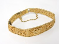 Lot 226 - A gold zodiac graduated filigree panel bracelet