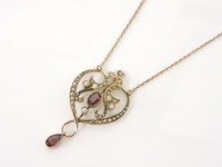 Lot 223 - An Edwardian gold split pearl and oval cut garnet pendant