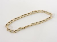 Lot 207 - A gold flat curb link chain bracelet