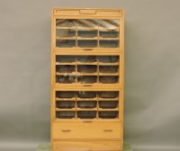 Lot 804 - An early to mid 20th century oak and glazed haberdashery cabinet