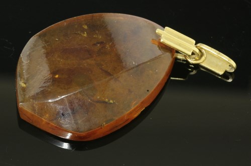 Lot 34 - An Art Deco carved amber pendant