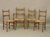 Lot 771 - A set of four Arts and Crafts oak and rush seated dining chairs