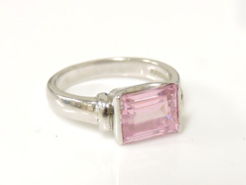 Lot 1015 - A 9ct white gold baguette cut pink cubic zirconia ring