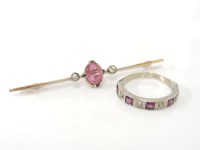 Lot 1012 - A gold oval cut pink tourmaline and diamond bar brooch