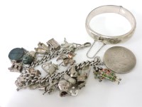Lot 1061A - A silver curb bracelet with various silver charms