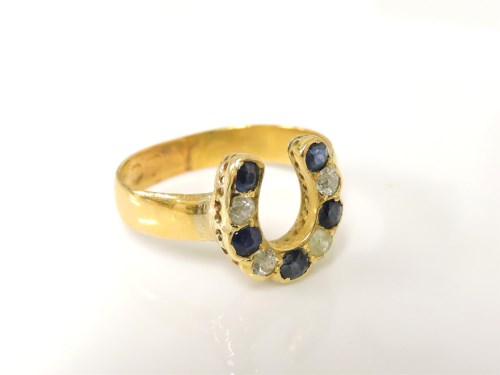 Lot 1045 - A gold diamond and sapphire horse shoe