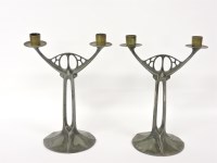 Lot 1210 - A pair of WMF silver plated twin branch candelabra