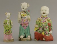 Lot 1202 - Three early 19th century famille rose figures