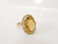 Lot 227 - A 9ct gold oval mixed cut citrine ring