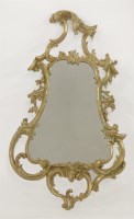 Lot 357 - A George III carved giltwood wall mirror of cartouche shape