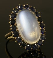 Lot 427 - A gold moonstone and sapphire oval cluster ring