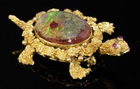 Lot 492 - A gold boulder opal and ruby set novelty turtle brooch