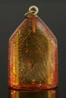 Lot 332 - A carved amber pendant