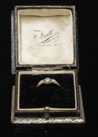 Lot 446 - An Art Deco three stone diamond ring