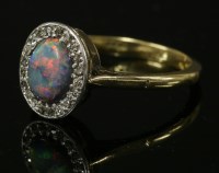 Lot 438 - A black opal and diamond oval cluster ring