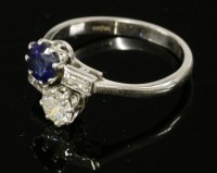 Lot 551 - A platinum two-stone sapphire and diamond crossover ring