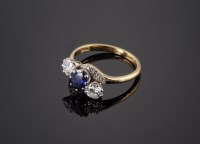 Lot 553 - A sapphire and diamond three-stone crossover ring