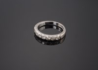 Lot 564 - An 18ct white gold diamond set half eternity ring