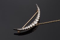 Lot 380 - A Victorian diamond set crescent brooch