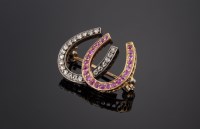 Lot 389 - A late Victorian ruby and diamond double horseshoe brooch