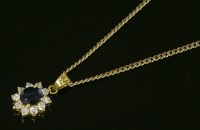 Lot 578 - A sapphire and diamond oval cluster pendant