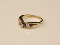 Lot 31 - A 9ct gold diamond and ruby wishbone ring