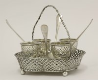 Lot 144 - An Edwardian silver swing-handled egg cruet