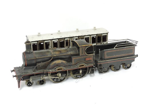 Lot 100 - A 4.4.0 gauge tinplate spirit-fired live steam locomotive tender and carriage