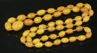 Lot 333 - A single row graduated olive-shaped amber bead necklace