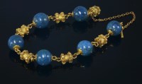 Lot 328 - An early Victorian gold and stained jasper bead bracelet