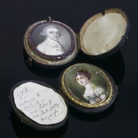 Lot 302 - A gold mounted portrait miniature pendant with a garnet border