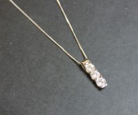 Lot 37 - An 18ct white gold three stone diamond pendant